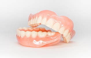 Full set of dentures on white background