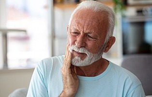 Bearded senior man with a toothache