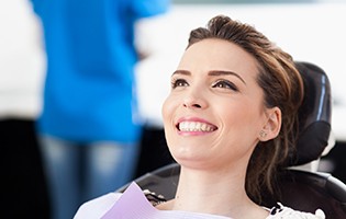 Female dental patient smiling in dental chair