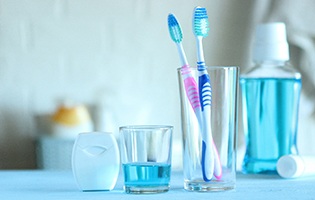 Toothbrushes and other oral hygiene products on bathroom counter