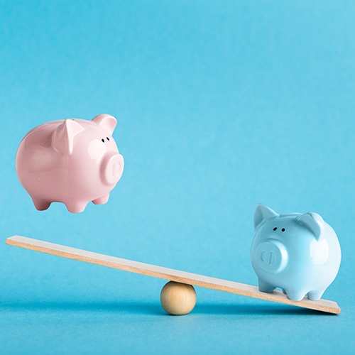 Piggy banks on a balance scale