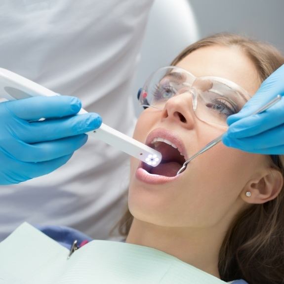 Dentist capturing photos of the mouth of a patient with an intraoral camera