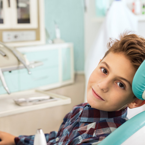a child sitting in a dental chair 