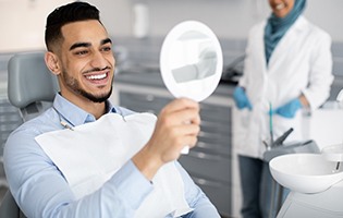 Man in treatment room smiling at reflection