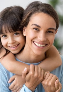 Mom and daughter smiling together