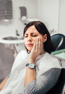 Woman with toothache at dentist's office