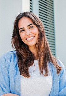 Woman with white teeth smiling while standing outside